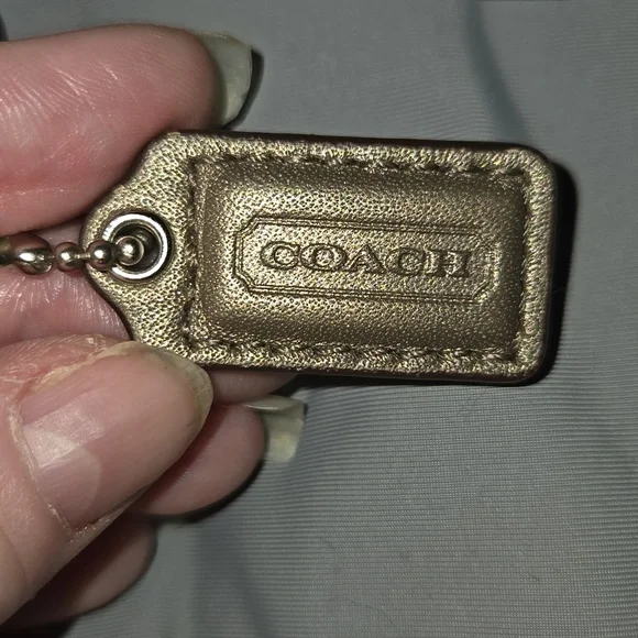 Coach metallic bronze wristlet featuring a detachable strap and a embossed logo - Picture 3 of 7